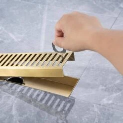 2.75 In. W X 12 In D Grid Shower Drain Stainless Steel Decorative Drain Cover With Brushed Gold -Tahanbath brushed gold tahanbath shower drains q pzz 7002lsj 12 1f 1000